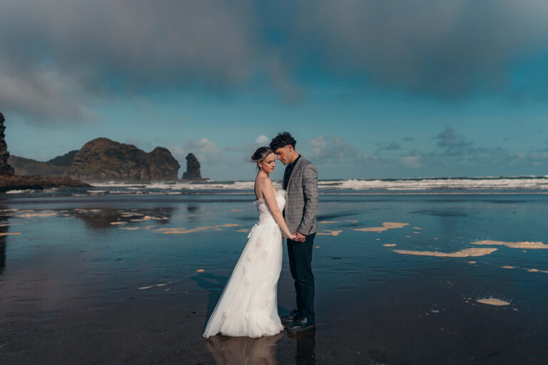 Elopement & mini wedding photographer Auckland — couple on Piha beach at sunrise
